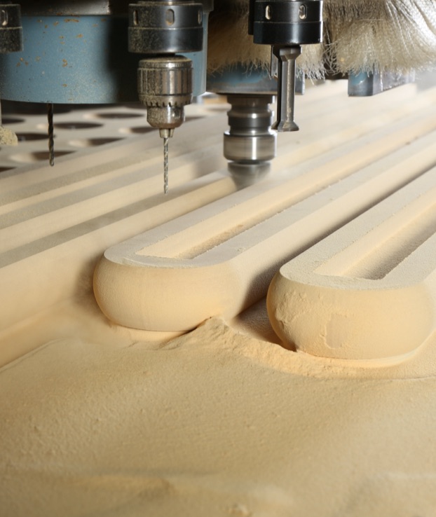 Close-up of CNC machine doing custom shape in wood.