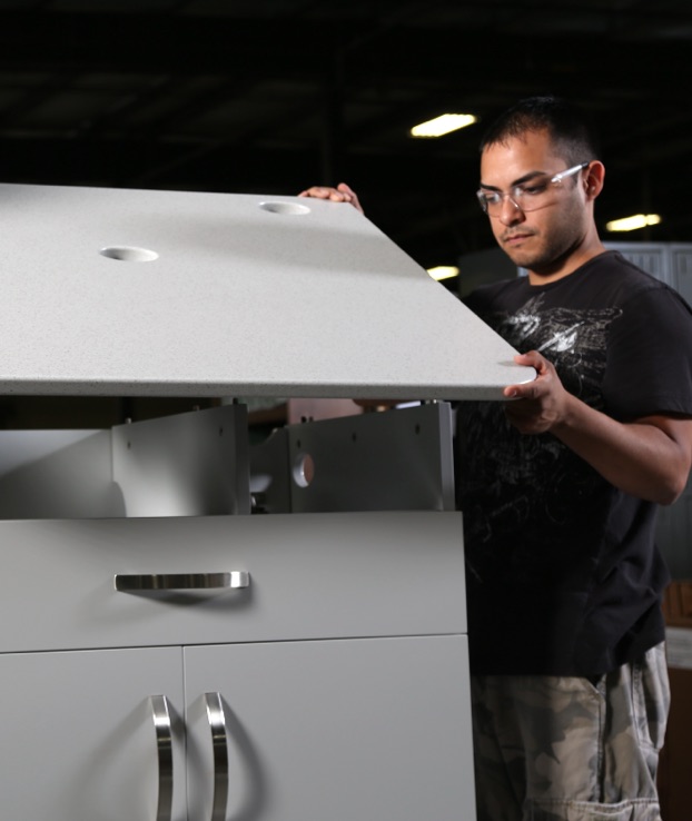 Man assembling top on custom laminate furniture.