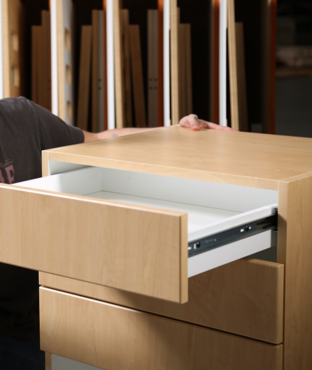 Assembled casework components with drawer sliding out, staged in Paladin’s manufacturing facility.