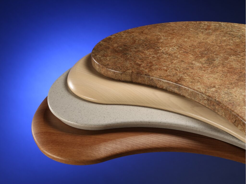 Finished membrane-pressed shapes stacked to highlight colors and patterns.