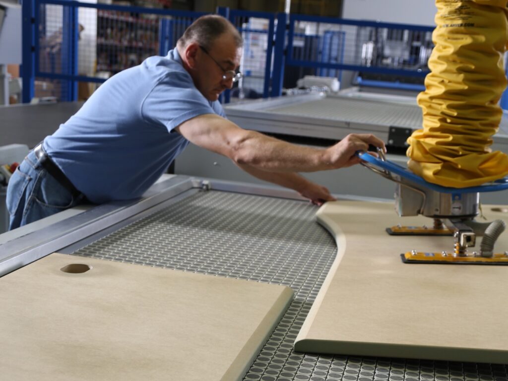 Paladin technician working the membrane pressing machine.