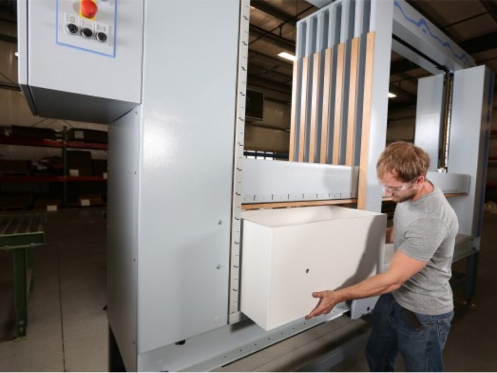An operator using case clamp technology with detail view of finished cabinetry casing.